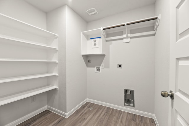 16535 Willow Forest Dr, Conroe, TX 77302 - laundry area with hookup for a washing machine, electric dryer hookup, dark wood-style flooring, and baseboards