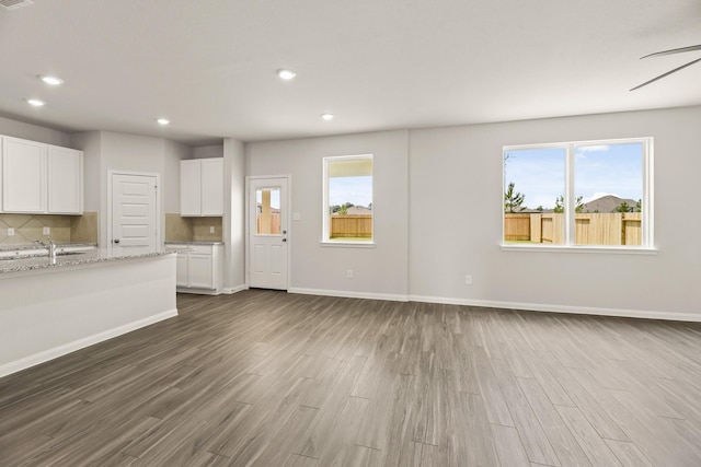 16535 Willow Forest Dr, Conroe, TX 77302 - unfurnished living room featuring dark wood finished floors, recessed lighting, a sink, baseboards, and a ceiling fan