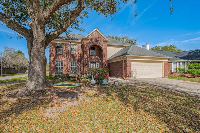 traditional home featuring brick siding, an attached garage, and driveway