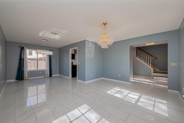 unfurnished living room featuring stairway, baseboards, visible vents, and a chandelier