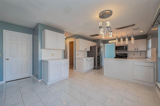 kitchen featuring visible vents, light countertops, white cabinets, stainless steel appliances, and a sink