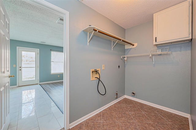 washroom featuring electric dryer hookup, dark tile patterned floors, hookup for a gas dryer, hookup for a washing machine, and laundry area