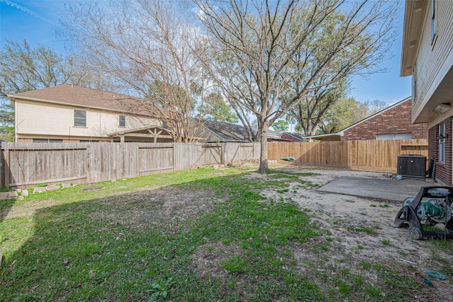 view of yard with a patio area, central AC unit, and a fenced backyard