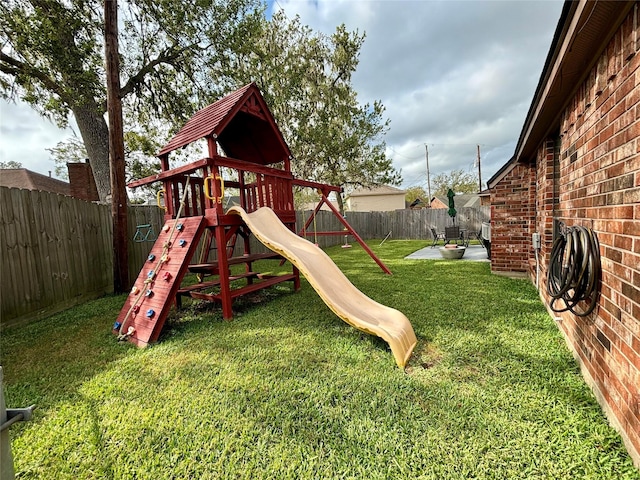 view of play area featuring a yard, a patio, and a fenced backyard