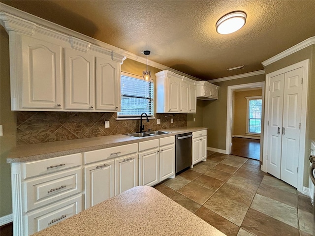 kitchen featuring a sink, white cabinetry, light countertops, dishwasher, and pendant lighting