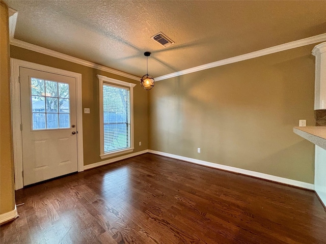 interior space featuring dark wood-style flooring, visible vents, ornamental molding, a textured ceiling, and baseboards