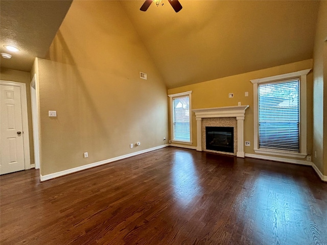 unfurnished living room with a fireplace, visible vents, dark wood-type flooring, a ceiling fan, and baseboards