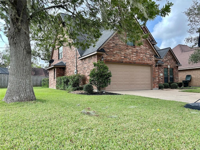 traditional-style house featuring a front yard, concrete driveway, brick siding, and an attached garage