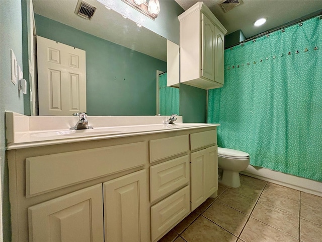 full bathroom featuring toilet, a sink, visible vents, and tile patterned floors