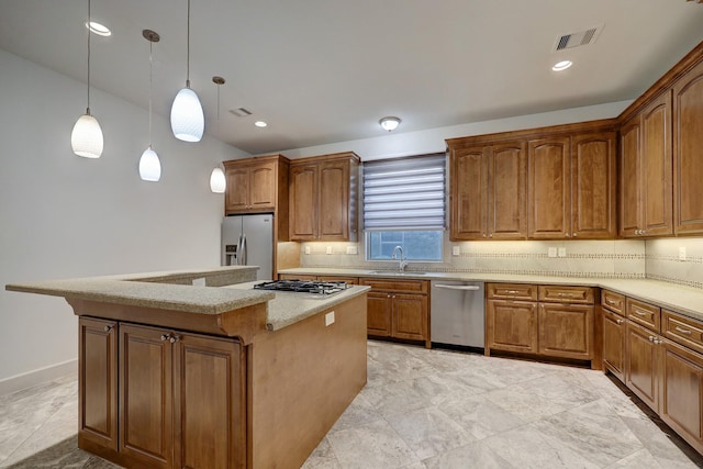 kitchen featuring hanging light fixtures, appliances with stainless steel finishes, brown cabinetry, and a center island