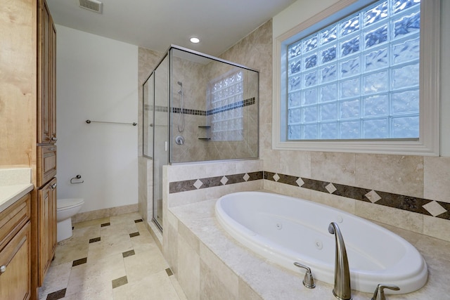 bathroom featuring toilet, vanity, visible vents, a shower stall, and a tub with jets