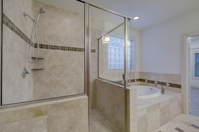 bathroom featuring a shower stall and a bath