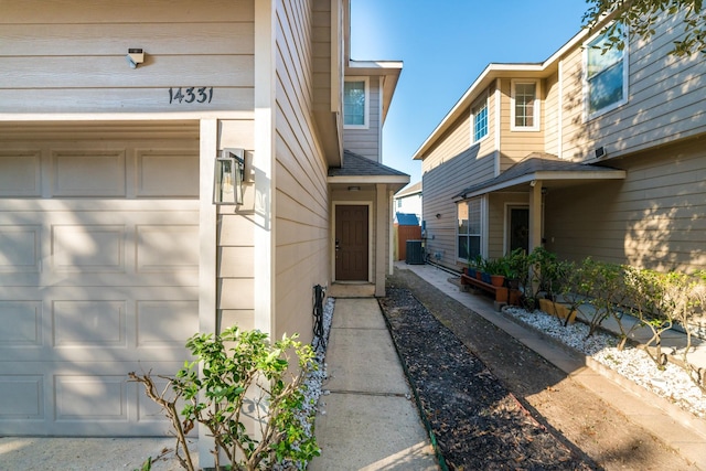 14331 Melody Glen Ln, Houston, TX 77014 - property entrance with a garage and central air condition unit