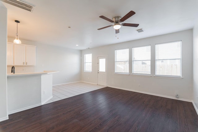 14331 Melody Glen Ln, Houston, TX 77014 - unfurnished living room with wood finished floors, a ceiling fan, and baseboards