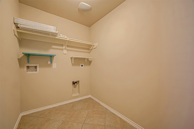 laundry area with laundry area, baseboards, hookup for a washing machine, tile patterned flooring, and hookup for an electric dryer