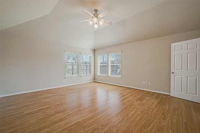 spare room with vaulted ceiling, ceiling fan, baseboards, and light wood-style floors