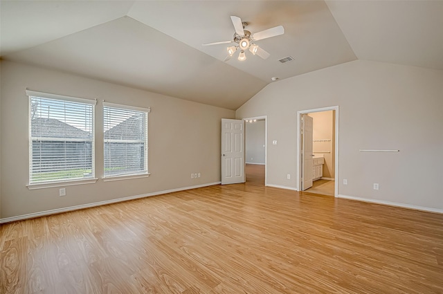 unfurnished bedroom featuring vaulted ceiling, baseboards, visible vents, and light wood-style floors