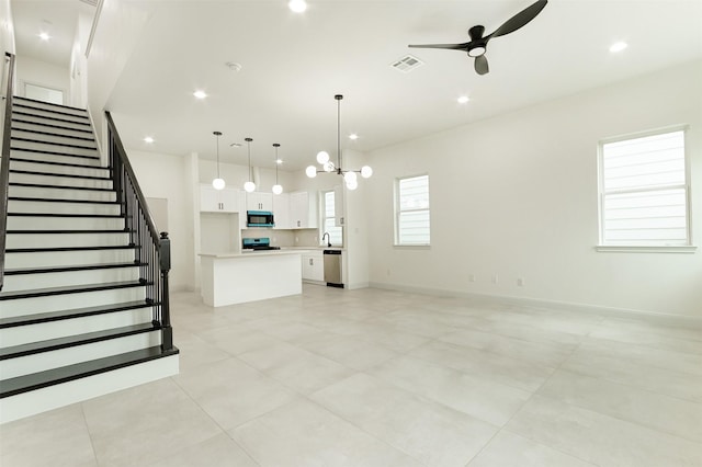 unfurnished living room featuring recessed lighting, baseboards, ceiling fan, and stairs