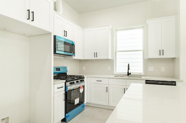 kitchen featuring a sink, light countertops, white cabinetry, and stainless steel appliances