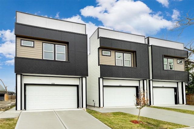 modern home featuring concrete driveway, a garage, and stucco siding