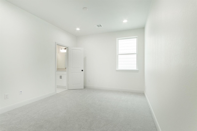 spare room featuring recessed lighting, visible vents, baseboards, and light colored carpet