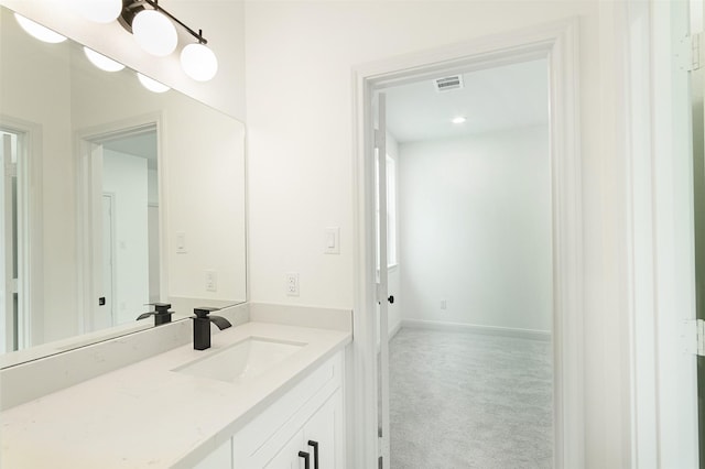 bathroom with visible vents, baseboards, and vanity