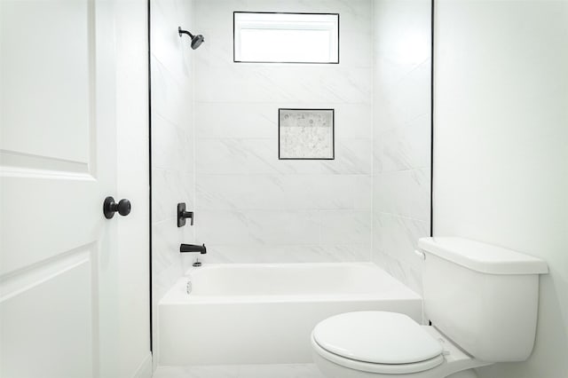 bathroom featuring toilet and shower / tub combination