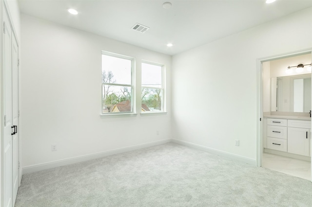 unfurnished bedroom with light carpet, visible vents, and recessed lighting