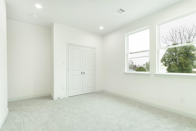 unfurnished bedroom with recessed lighting, visible vents, baseboards, and carpet flooring