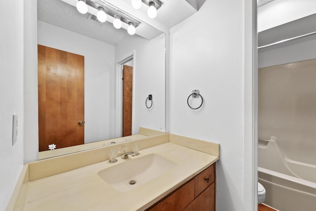 bathroom with toilet, shower / tub combination, and vanity