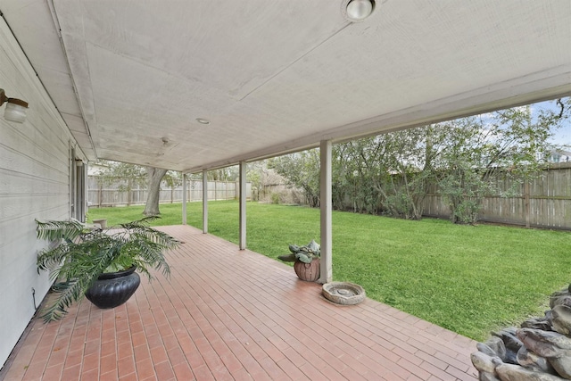 deck with a fenced backyard and a yard