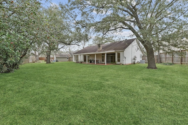 view of yard featuring a patio area and a fenced backyard