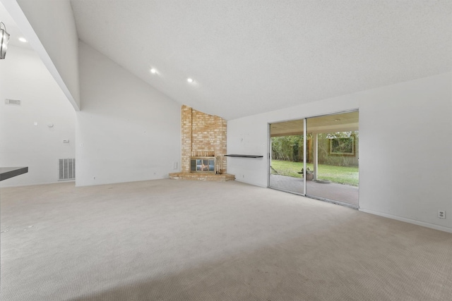 unfurnished living room featuring high vaulted ceiling, recessed lighting, light colored carpet, a fireplace, and visible vents