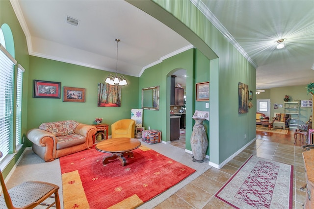 living area with a chandelier, ornamental molding, light tile patterned flooring, and visible vents