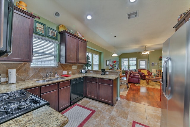 kitchen featuring decorative light fixtures, visible vents, a sink, a peninsula, and black appliances