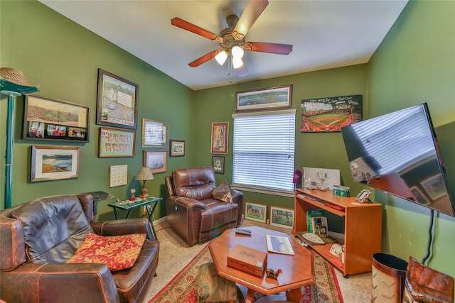 living area with carpet flooring, a ceiling fan, and baseboards