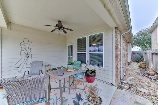 view of patio / terrace with fence and a ceiling fan