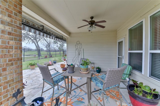 view of patio / terrace with fence and a ceiling fan