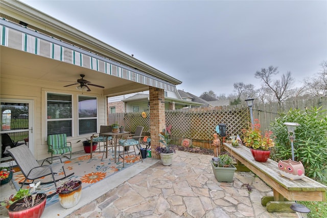 view of patio / terrace featuring outdoor dining area, fence, and ceiling fan