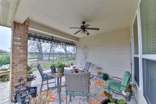 view of patio / terrace with ceiling fan and fence