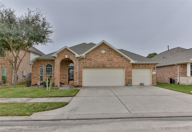 view of front facade featuring a garage, driveway, a shingled roof, a front lawn, and brick siding