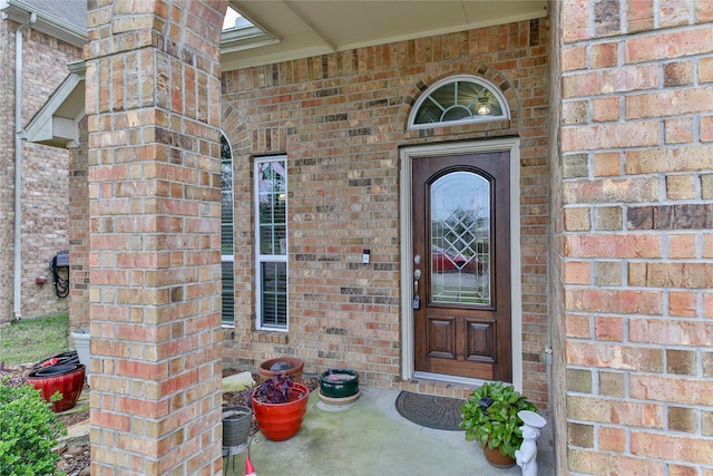 property entrance with brick siding