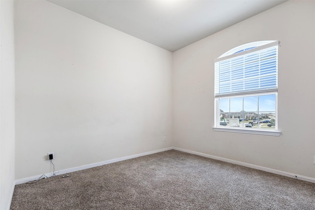 carpeted spare room with baseboards