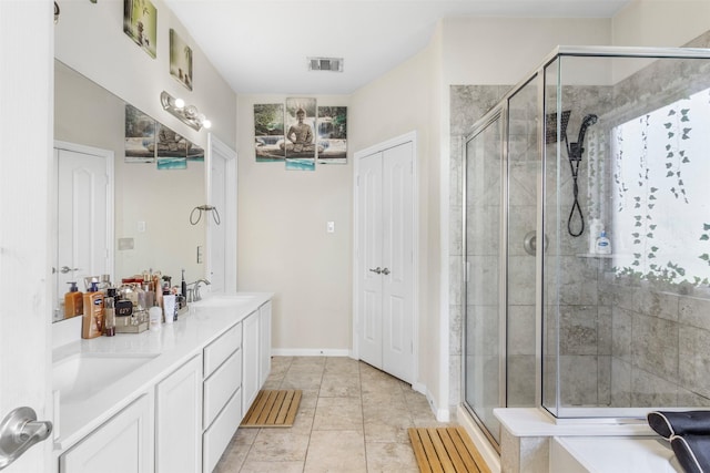 full bathroom with double vanity, visible vents, a sink, a shower stall, and a closet