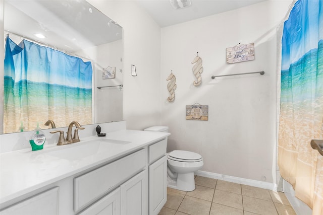 bathroom featuring toilet, curtained shower, vanity, and tile patterned floors