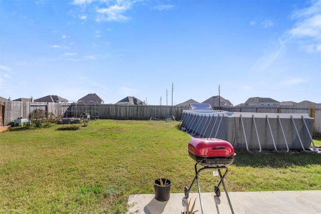 view of yard featuring a pool and a fenced backyard