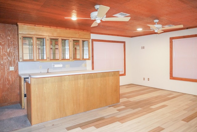 kitchen featuring wood ceiling, light countertops, visible vents, and a peninsula