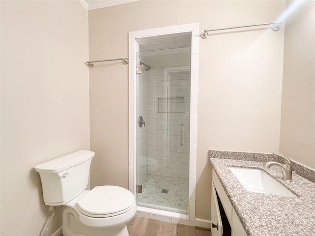 full bath featuring vanity, wood finished floors, a shower stall, and toilet