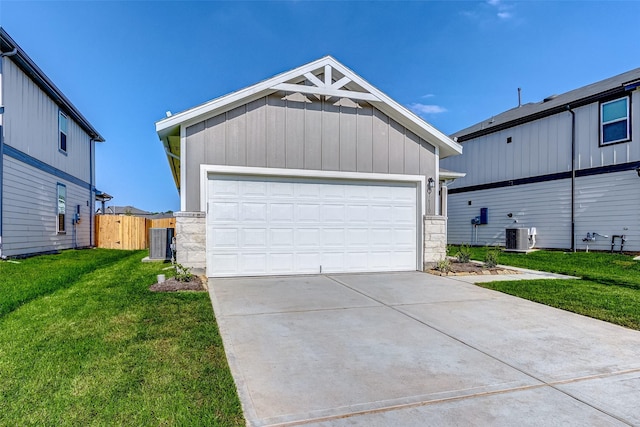 view of front facade featuring central air condition unit, a gate, a garage, stone siding, and a front lawn