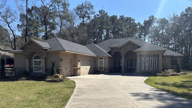 ranch-style home featuring stone siding, stucco siding, french doors, and a garage